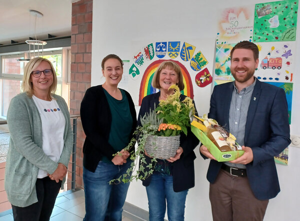 Bild vergr&ouml;&szlig;ern: Auf dem Bild stehe Vanessa Rothermund, Julia Carluccio , Kerstin Bock und Julian Sprenger nebeneinander. Kerstin Bock hält eine bepflanze Blumenschlae in den Händen und Julian Sprenger ein Präsent.
