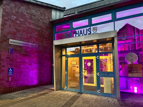 Bild vergr&ouml;&szlig;ern: Der Eingangsbereich des pink erleuchteten Rathauses in Lehre.